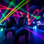 Participants engaging in an exciting game of laser tag, wearing vibrant gear in a colorful arena.