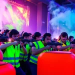 Players engage in intense laser tag action in a dynamic, neon-lit arena.