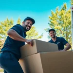 Movers calgary team loading furniture into a truck in a sunny neighborhood.