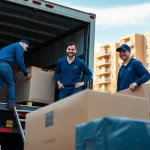 Movers in Toronto efficiently loading furniture into a moving truck in a vibrant urban setting.