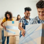 Queens movers expertly packaging furniture in a bright home environment for a smooth relocation.